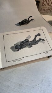 Plastic SCUBA diver toy and an ink and watercolor wash sketch of him