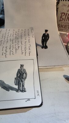 A female pilot model from the women in industry Toob set from Safari, Ltd. and an ink and watercolor wash sketch