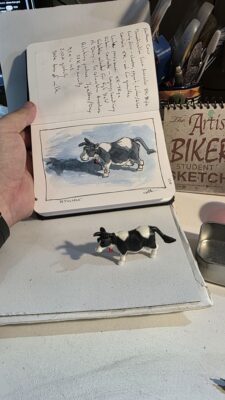 A northern cow miniature model and an ink and watercolor wash sketch