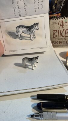 A miniature model of a Husky and an ink and watercolor wash illustration