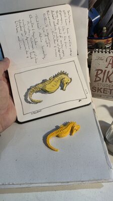 A miniature seahorse model and an ink and watercolor wash illustration