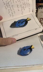 Blue tang miniature model and an ink and watercolor wash sketch
